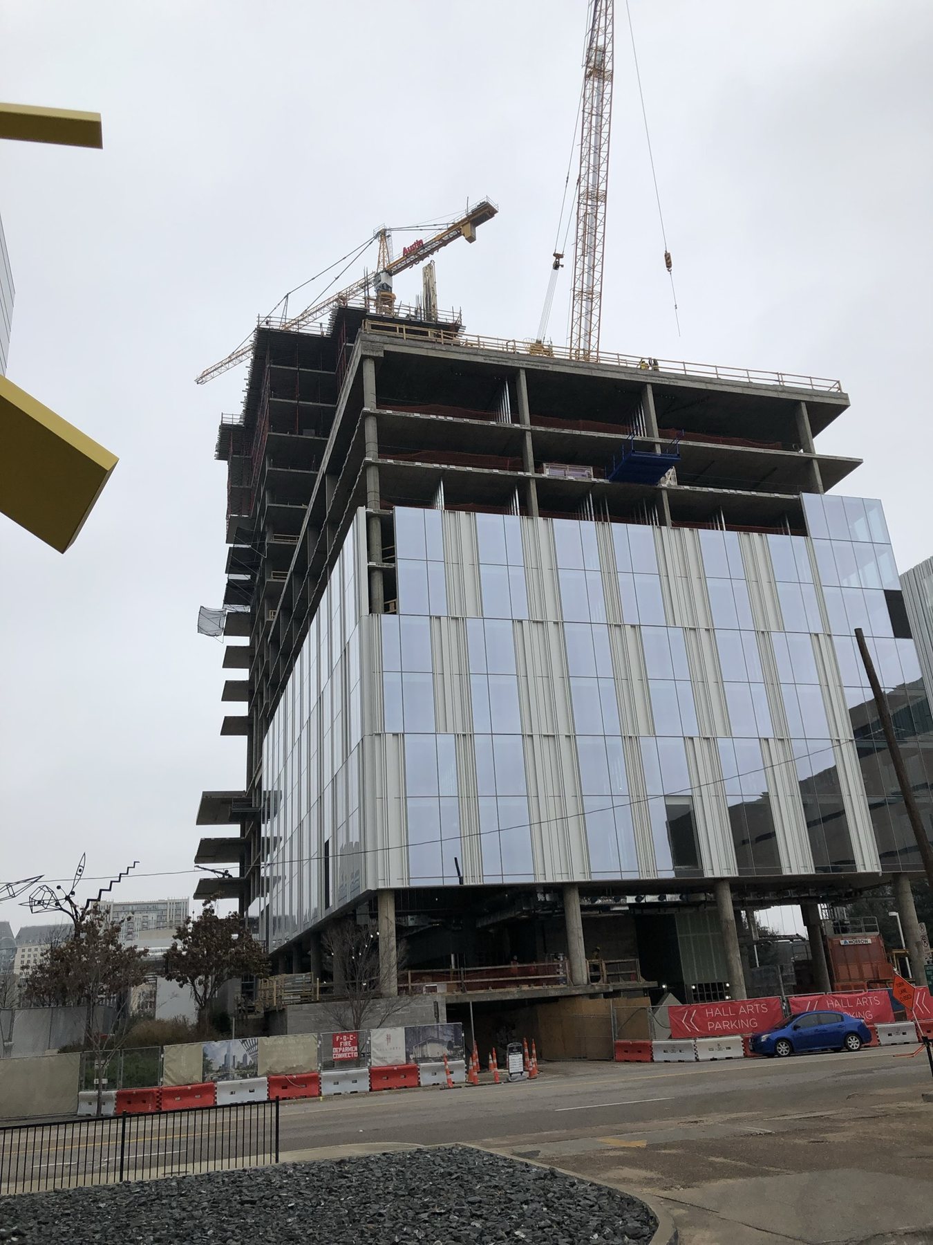 Hall Arts Hotel from the street, glass facade installed and upper floors still in concrete
